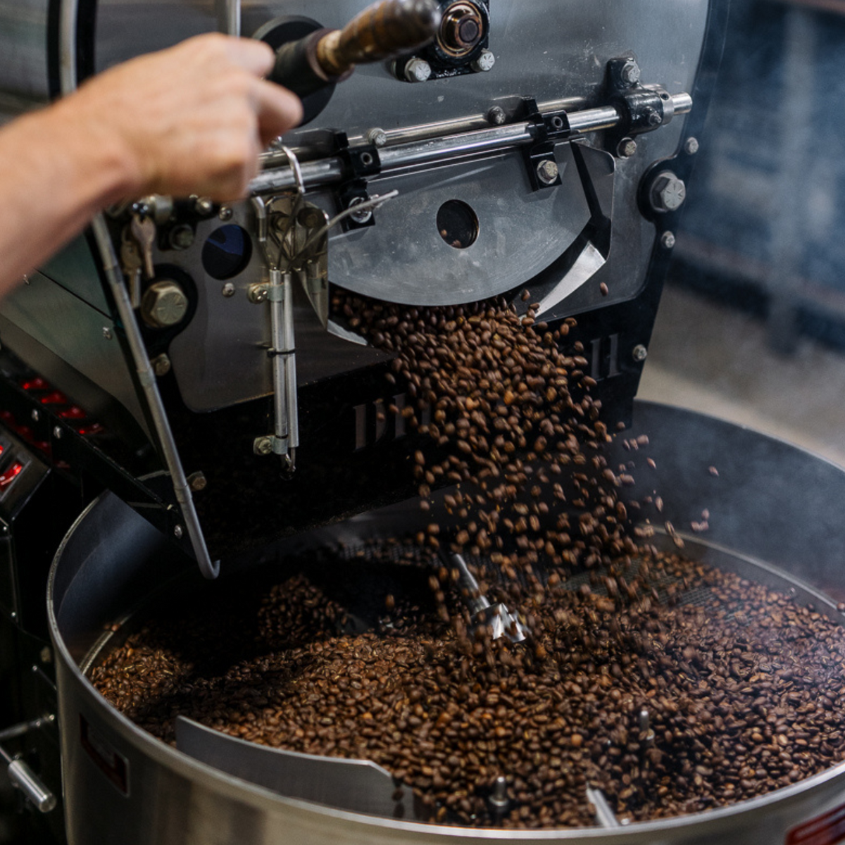 Roasted coffee beans dropping from the roaster drum