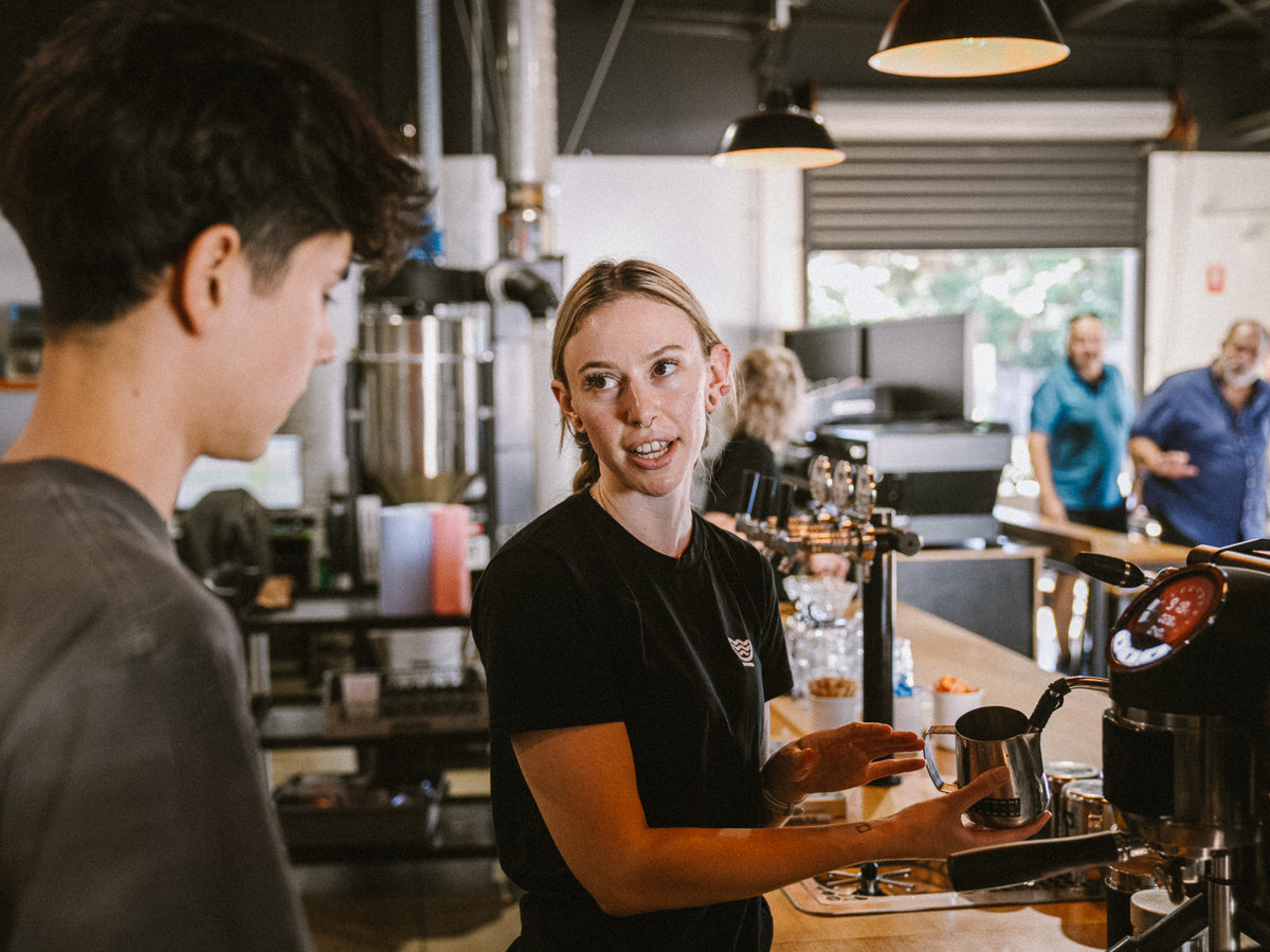 River City Coffee Roasters barista chatting with a customer at the counter